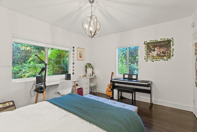 bedroom with dark wood-type flooring and a chandelier