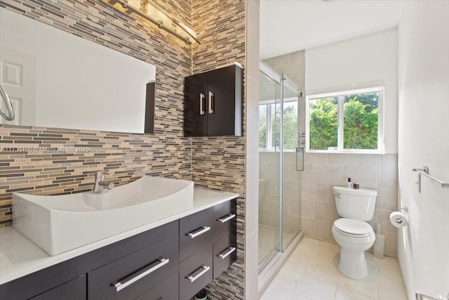 bathroom with tile patterned flooring, vanity, toilet, and walk in shower