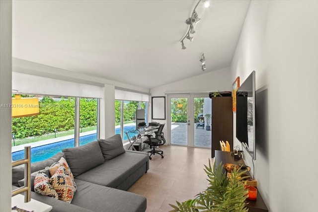 sunroom / solarium featuring lofted ceiling and french doors