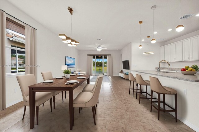 dining room featuring sink and light tile patterned floors