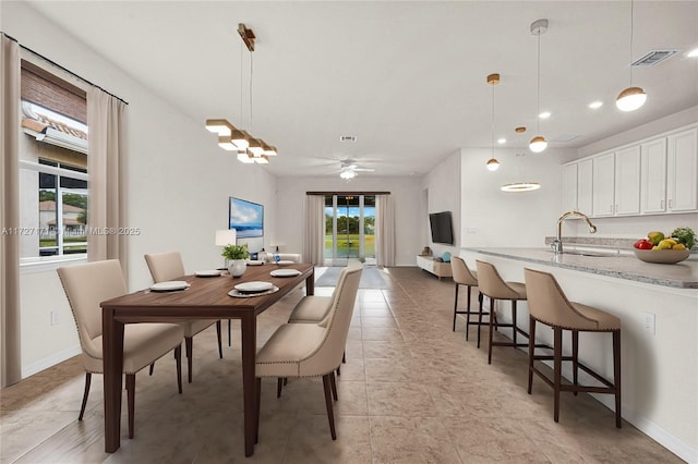 dining room with sink and light tile patterned flooring