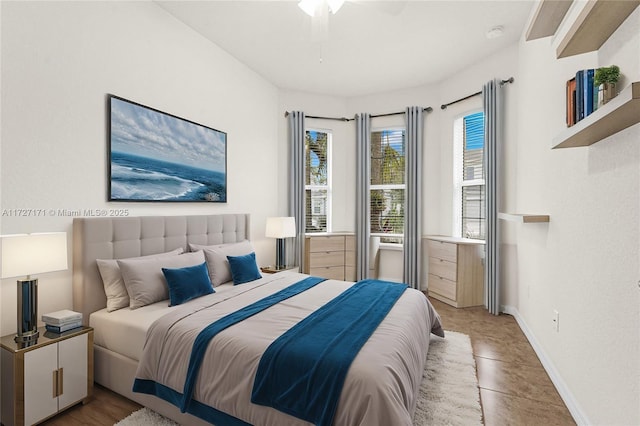 tiled bedroom featuring ceiling fan