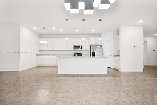 kitchen featuring pendant lighting, light tile patterned floors, stainless steel appliances, an island with sink, and white cabinets