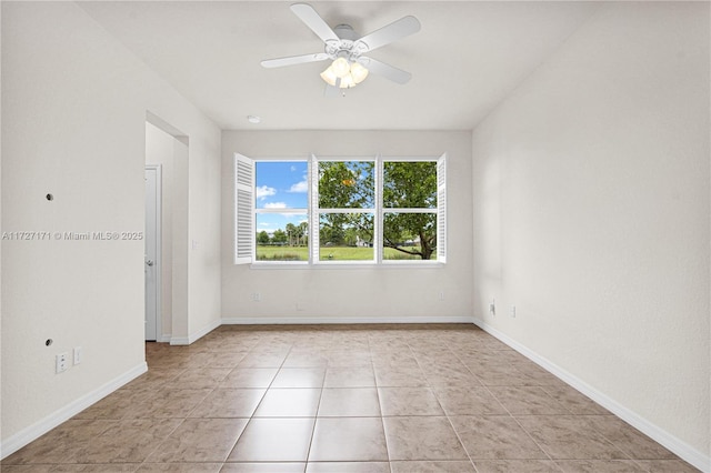 spare room featuring ceiling fan and light tile patterned floors