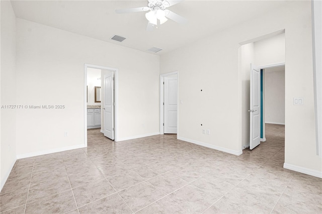 empty room with ceiling fan and light tile patterned floors