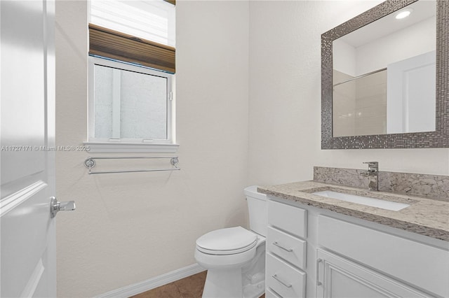 bathroom featuring vanity, a shower, and toilet