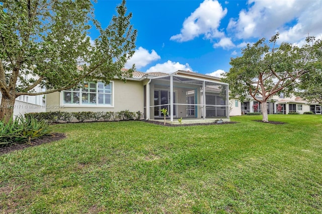 back of property with a patio area and a lawn