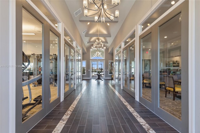 hallway with an inviting chandelier and french doors