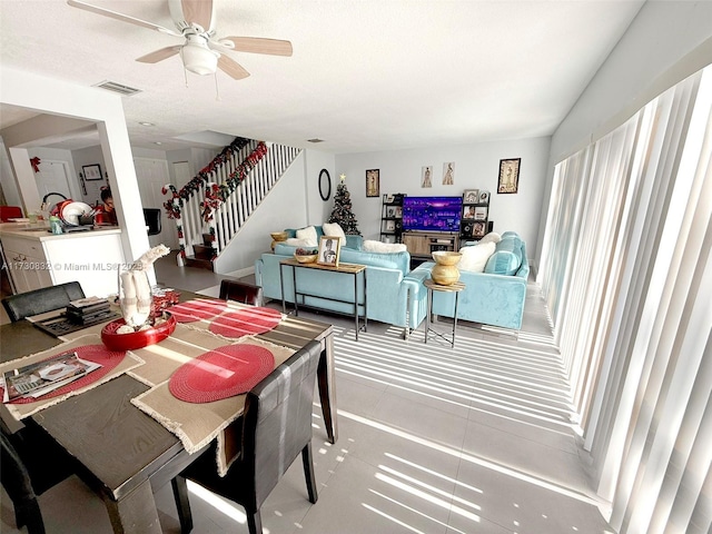 dining room with ceiling fan and tile patterned floors