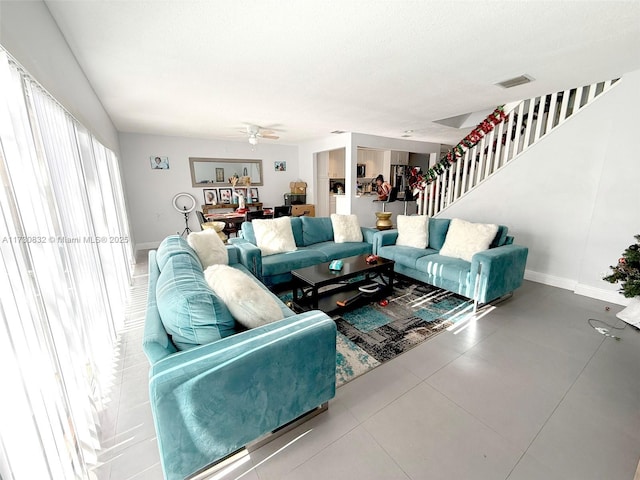 living room with a textured ceiling and ceiling fan