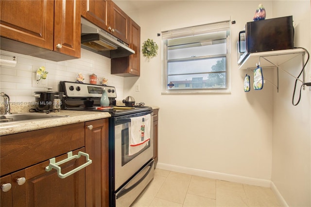 kitchen featuring backsplash, light tile patterned floors, sink, and stainless steel electric range oven