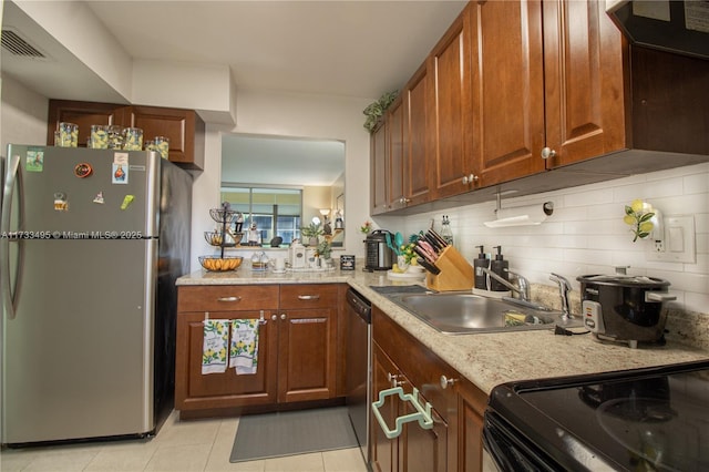 kitchen with light tile patterned flooring, appliances with stainless steel finishes, ventilation hood, sink, and decorative backsplash