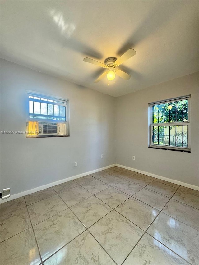 spare room featuring cooling unit and ceiling fan