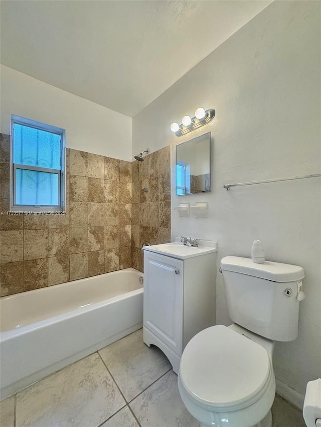 full bathroom featuring tiled shower / bath combo, vanity, and toilet