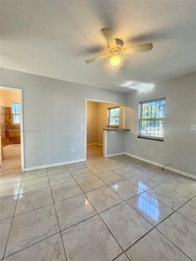 unfurnished room featuring a textured ceiling and ceiling fan