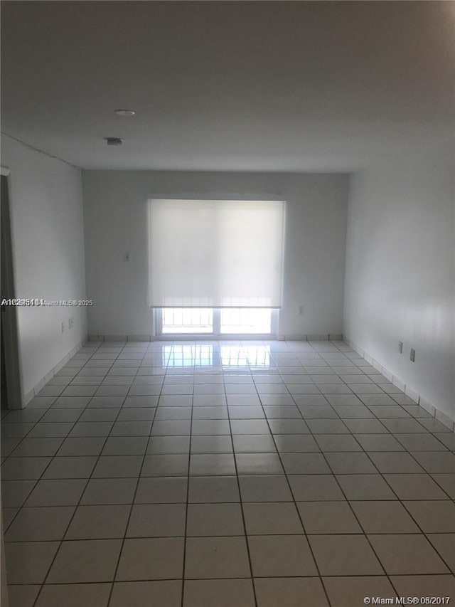 empty room with tile patterned floors