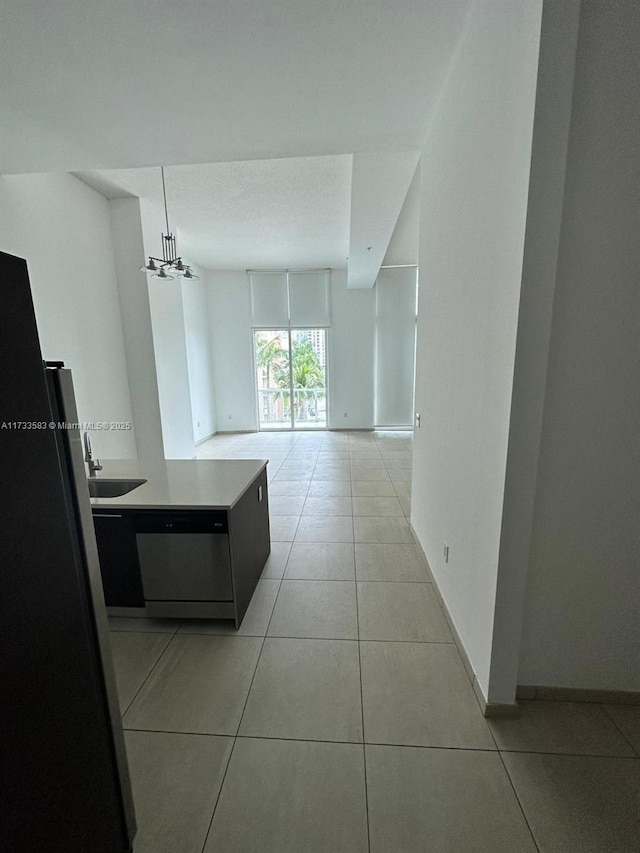 corridor with sink and light tile patterned floors