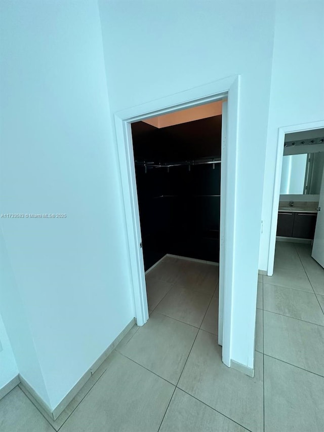 hallway featuring light tile patterned flooring