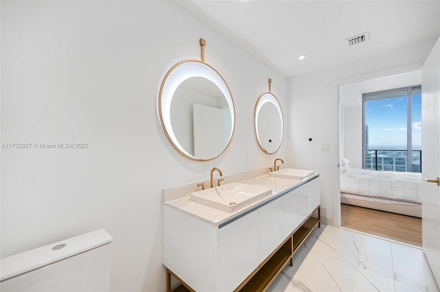 bathroom with vanity and toilet