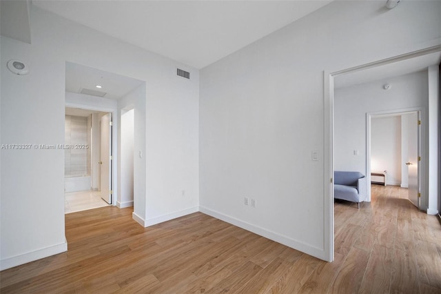 spare room featuring light hardwood / wood-style flooring