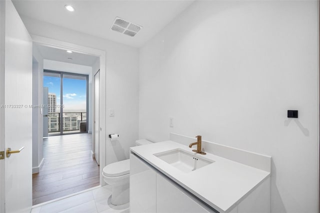 bathroom with vanity, tile patterned floors, and toilet