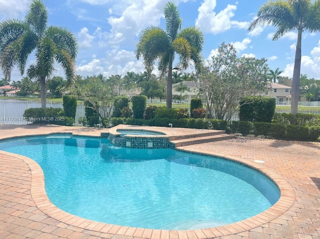 view of pool with an in ground hot tub and a patio area