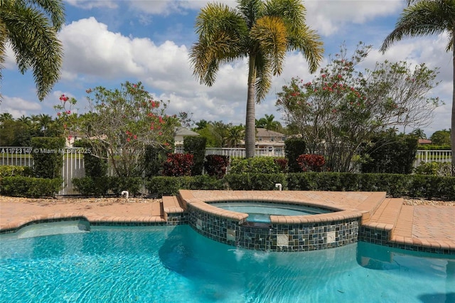 view of pool with an in ground hot tub