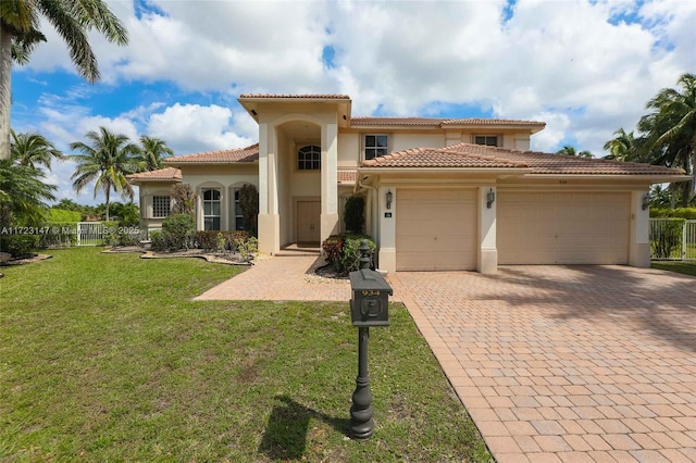 mediterranean / spanish-style home featuring a garage and a front yard