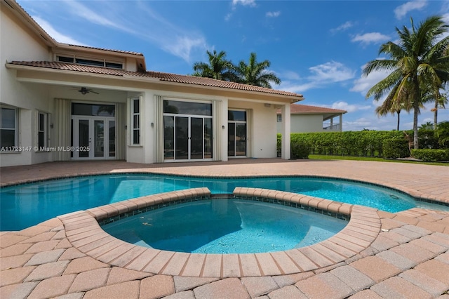 view of pool featuring an in ground hot tub, ceiling fan, a patio area, and french doors