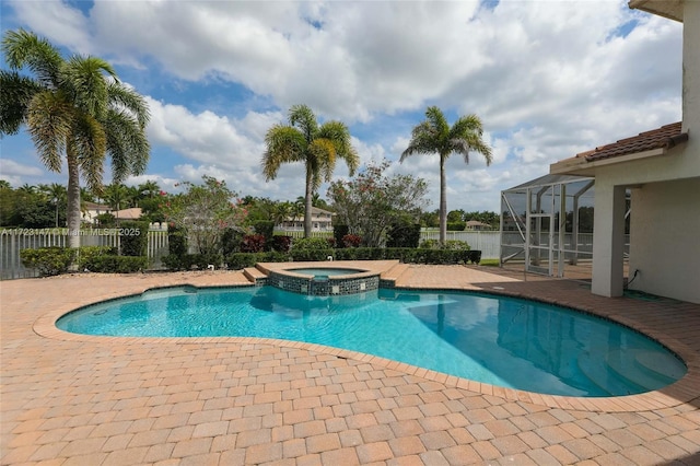 view of pool with a patio area and an in ground hot tub