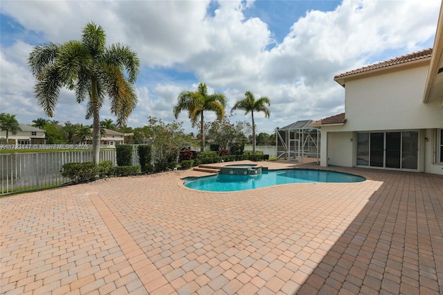 view of swimming pool with an in ground hot tub, a lanai, and a patio area