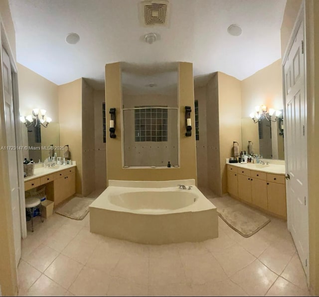 bathroom featuring a tub to relax in, tile patterned flooring, and vanity