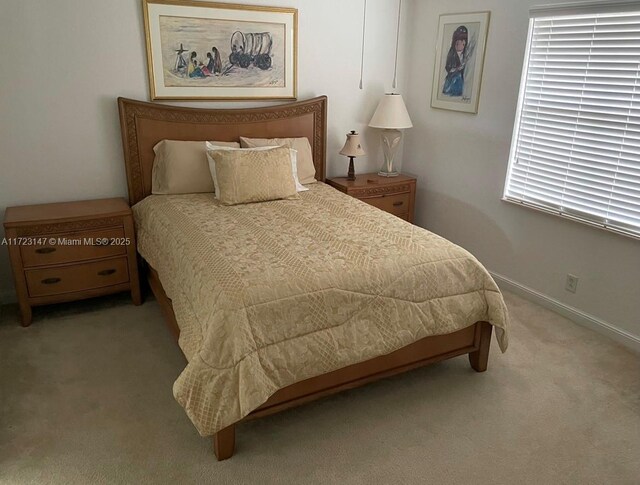 bedroom featuring light carpet