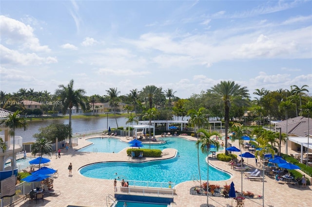 view of swimming pool featuring a pergola, a patio, and a water view