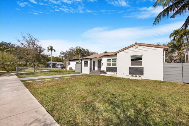 mediterranean / spanish house with a front yard