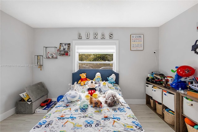 bedroom featuring wood finished floors and baseboards