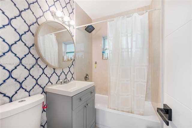 bathroom featuring toilet, shower / bath combination with curtain, and vanity