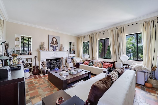 living area with ornamental molding, stone finish flooring, and a fireplace