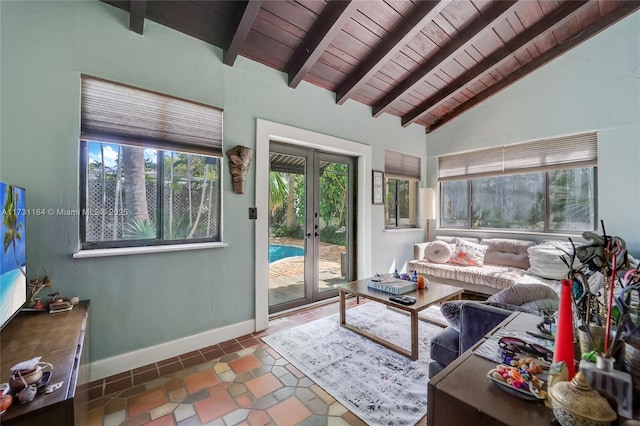 tiled living area with vaulted ceiling with beams, french doors, wood ceiling, and baseboards