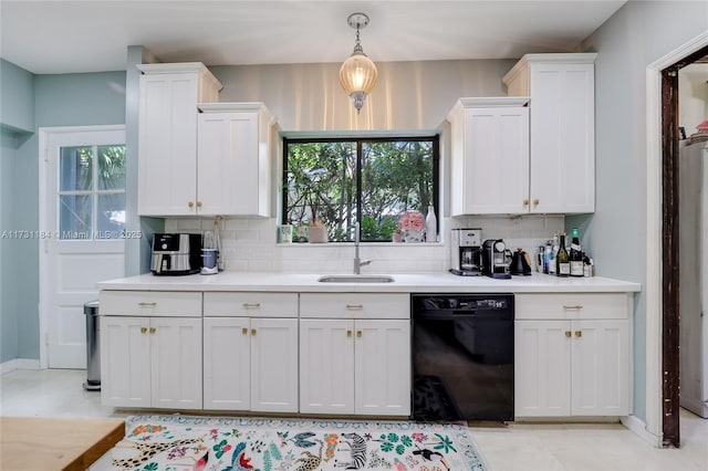 kitchen with black dishwasher, backsplash, white cabinetry, a sink, and plenty of natural light