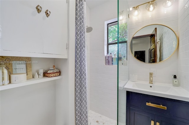 bathroom featuring tasteful backsplash, tile walls, tiled shower, and vanity