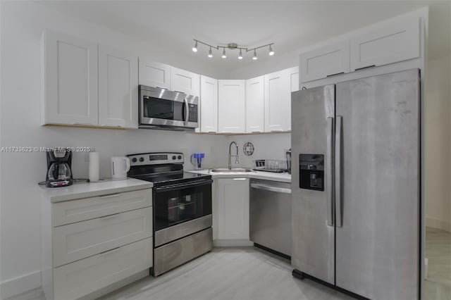 kitchen featuring white cabinetry, sink, and stainless steel appliances