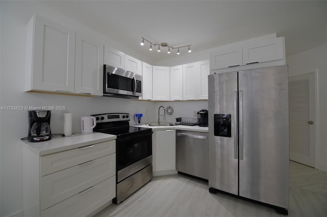 kitchen with white cabinetry, sink, and appliances with stainless steel finishes