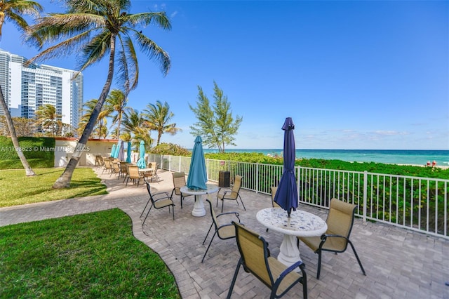 view of patio featuring a water view and a view of the beach