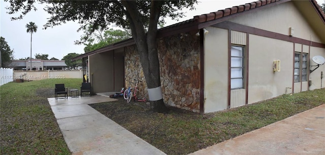 view of home's exterior featuring a yard and a patio area