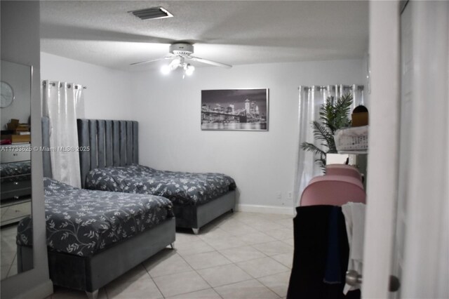 bedroom with a crib and tile patterned floors