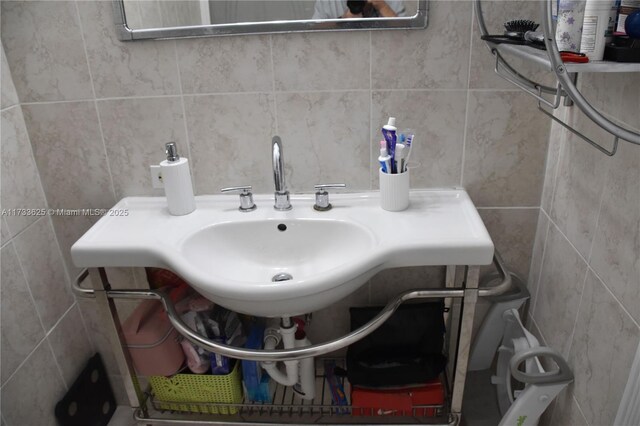 bathroom with tile walls and vanity