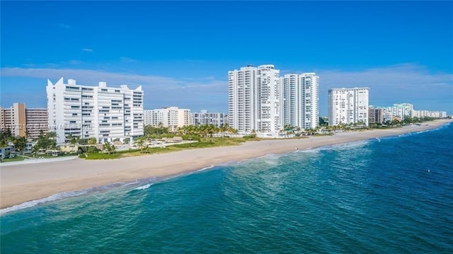 birds eye view of property with a view of the beach and a water view