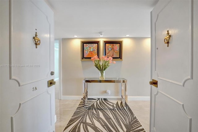 hallway featuring baseboards and recessed lighting