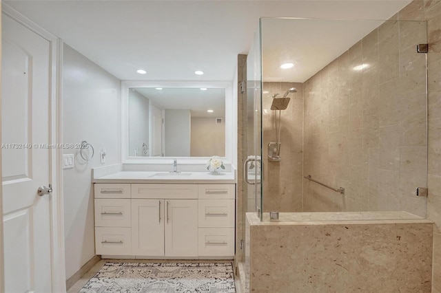 full bathroom featuring recessed lighting, baseboards, a shower stall, and vanity